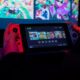 a person holding a nintendo wii game controller