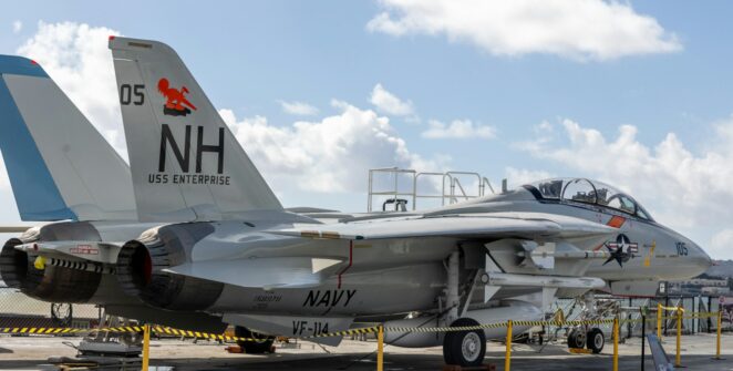 a fighter jet sitting on top of an airport tarmac