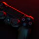 red and black sony ps 4 game controller