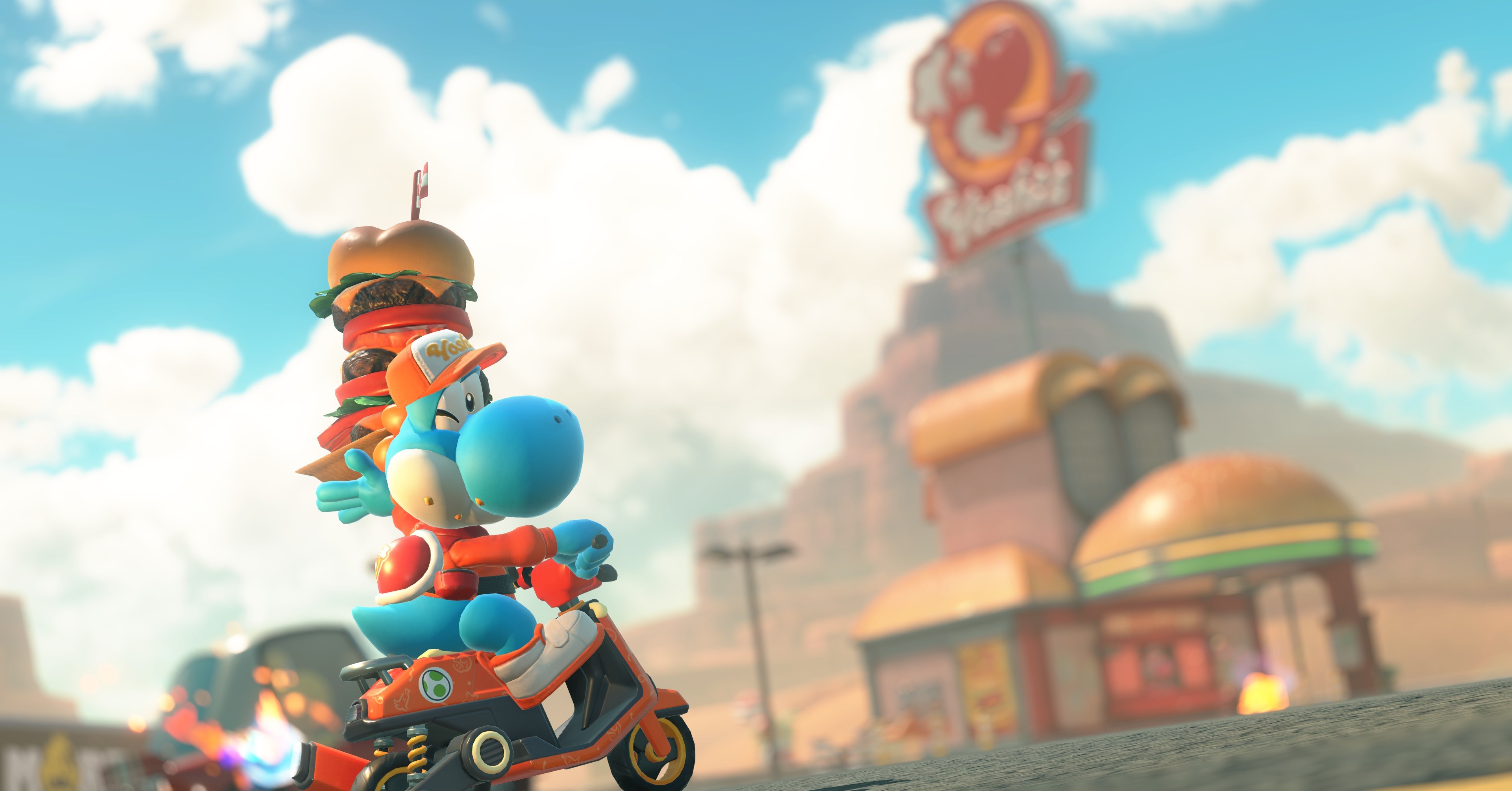 Um yoshi azul sustenta um hambúrguer empilhado do lado de fora de um drive-in de Yoshi em Mario Kart World