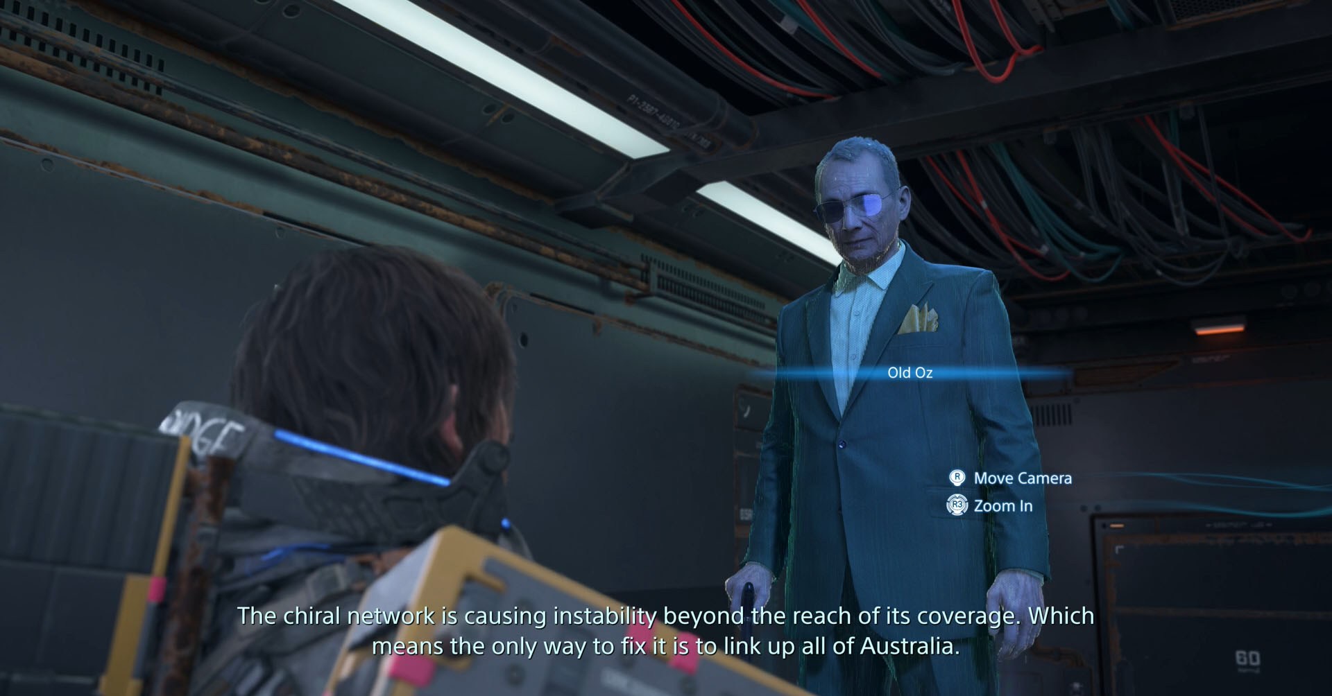 Uma captura de tela do Death Stranding 2 mostrando Sam conversando com o holograma de um velho chamado Old Oz.