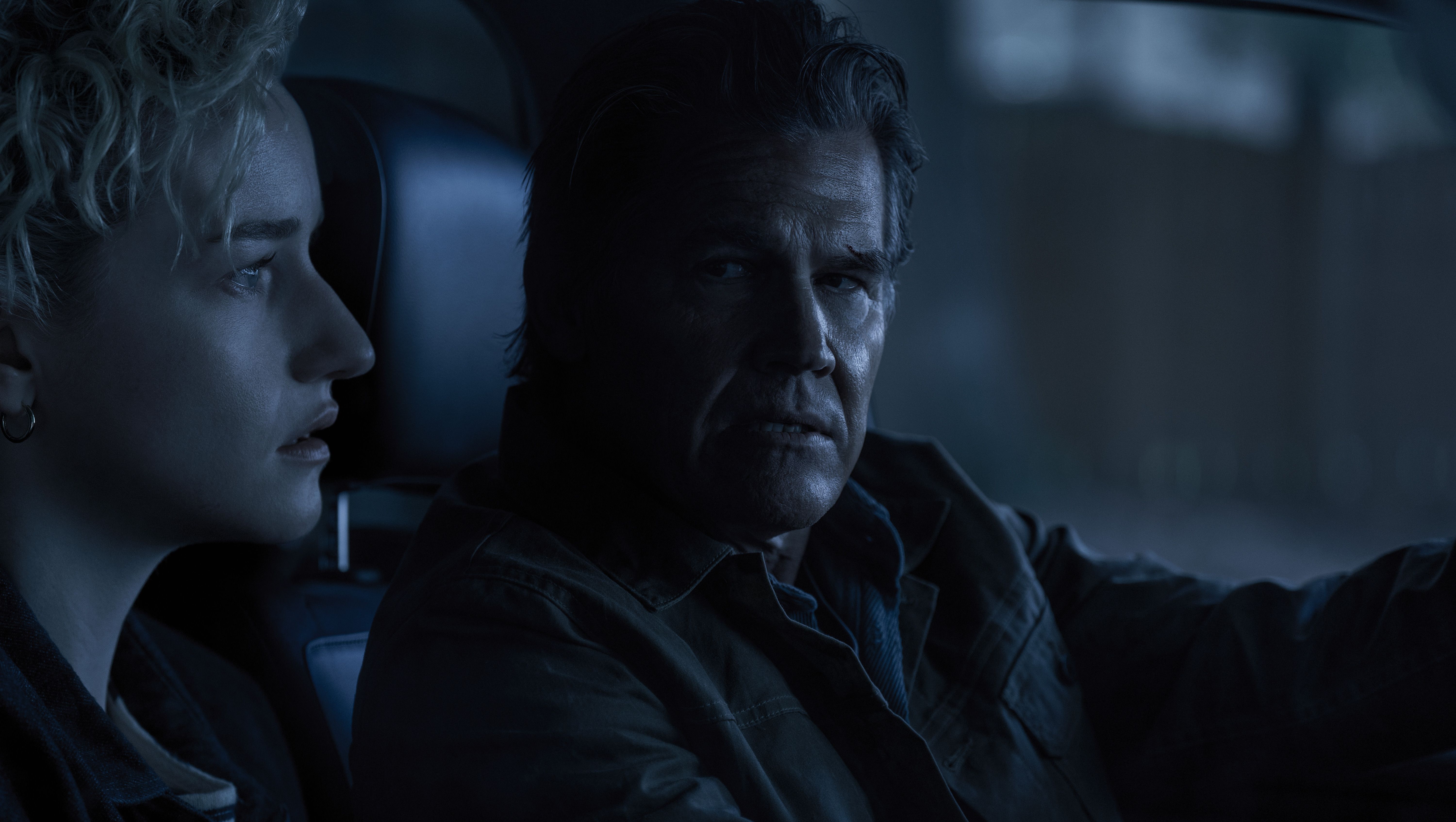 Justine (Julia Garner) e Archer (Josh Brolin) sentam -se no táxi escuro de uma caminhonete juntos à noite em armas