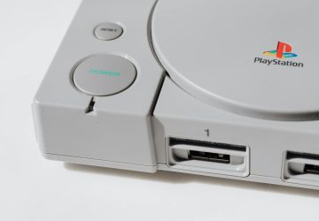 Close-up view of a classic PlayStation gaming console from the 90s, showcasing its iconic design.