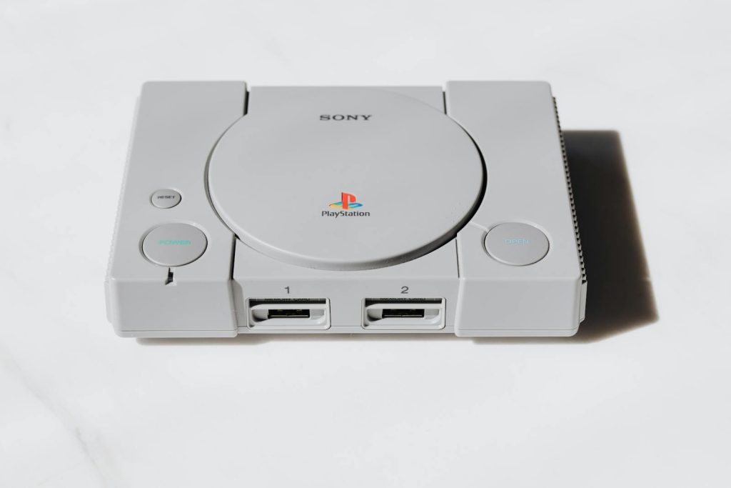 A classic Sony PlayStation console captured on a white background exuding retro gaming nostalgia.