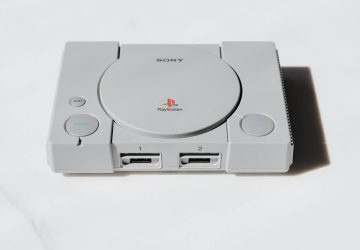 A classic Sony PlayStation console captured on a white background exuding retro gaming nostalgia.