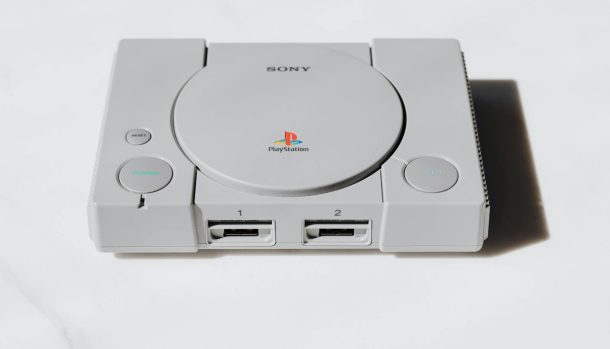 A classic Sony PlayStation console captured on a white background exuding retro gaming nostalgia.