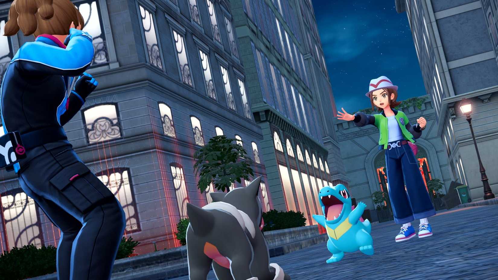 O treinador de Pokémon e seu Totodile lutando contra um treinador com um Houndor.