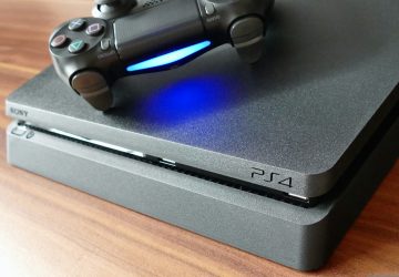 a video game console sitting on top of a wooden table