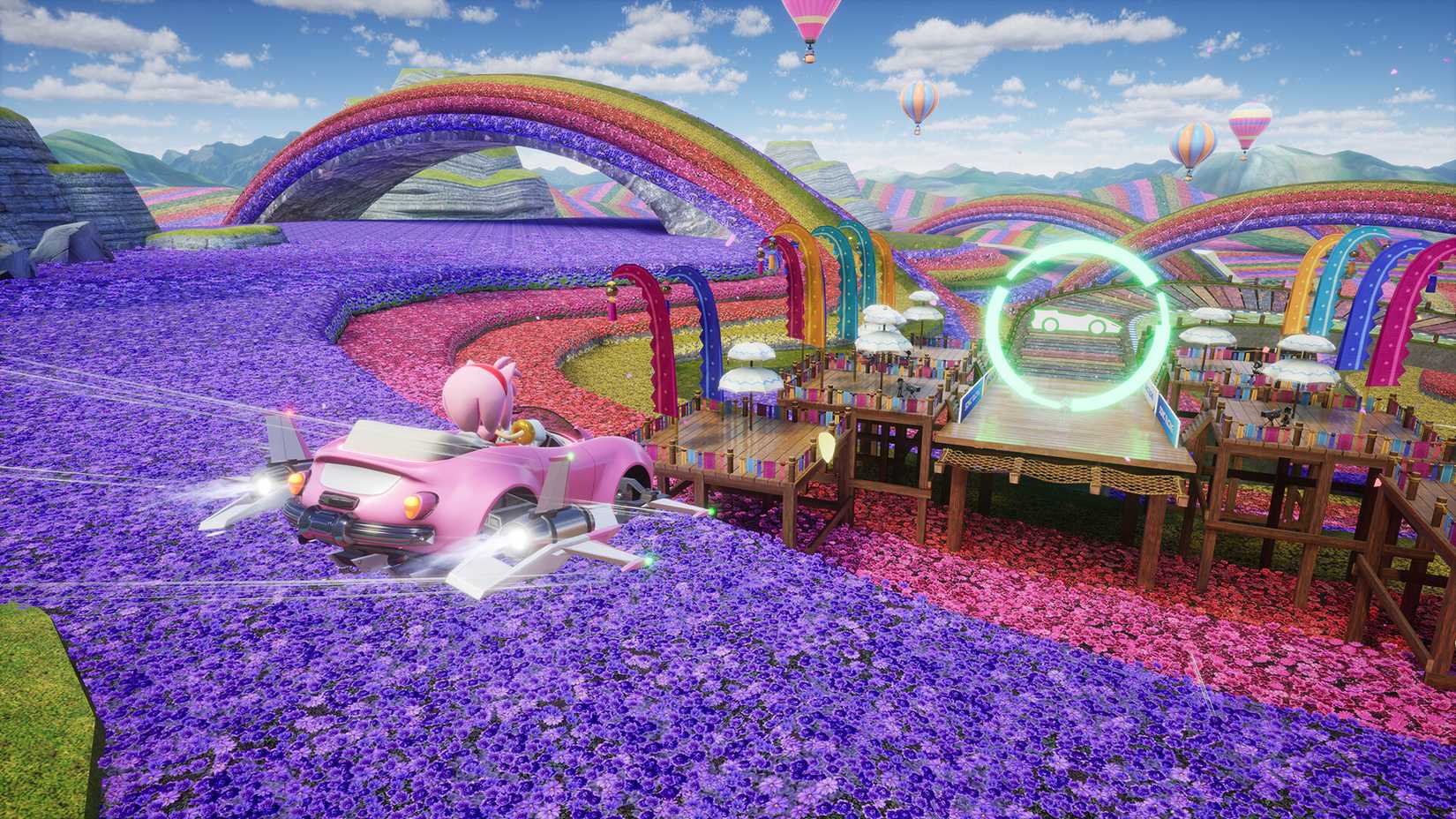 Amy voa sobre uma paisagem florida de arco -íris em Sonic Racing: Crossworlds