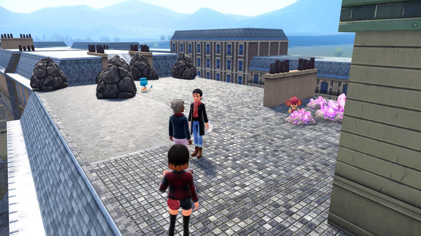 Um treinador se aproxima de Panpour e Pansear em um telhado em Pokémon Legends: ZA