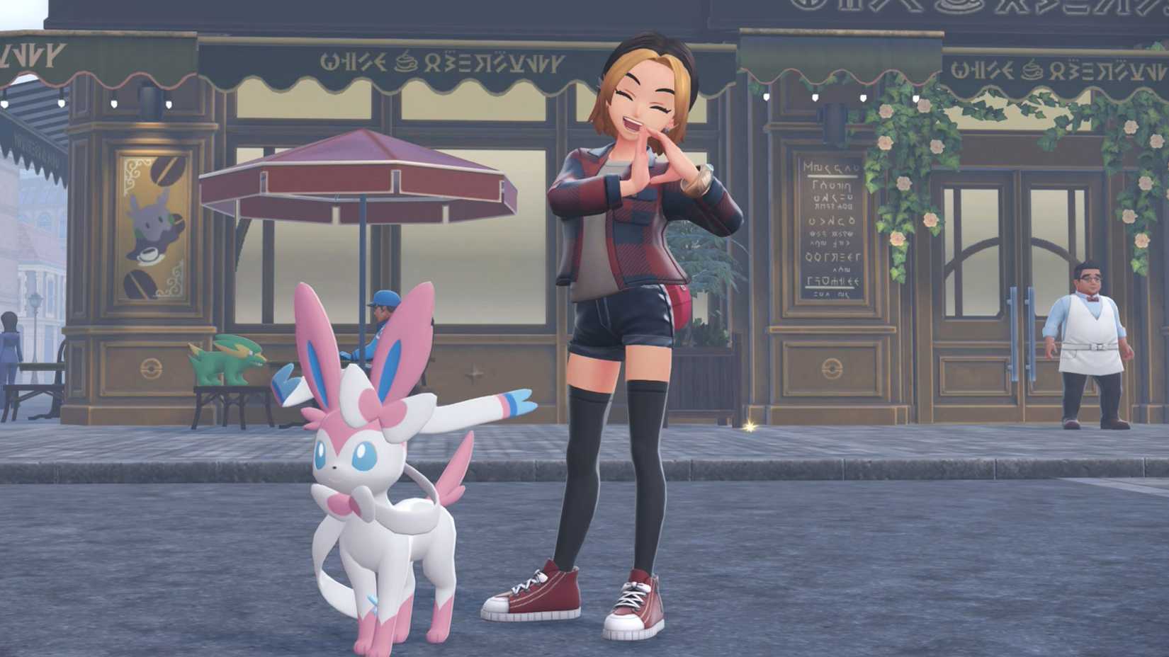 Uma treinadora posa com um formato de D nas mãos com um Sylveon em Pokémon Legends: ZA.