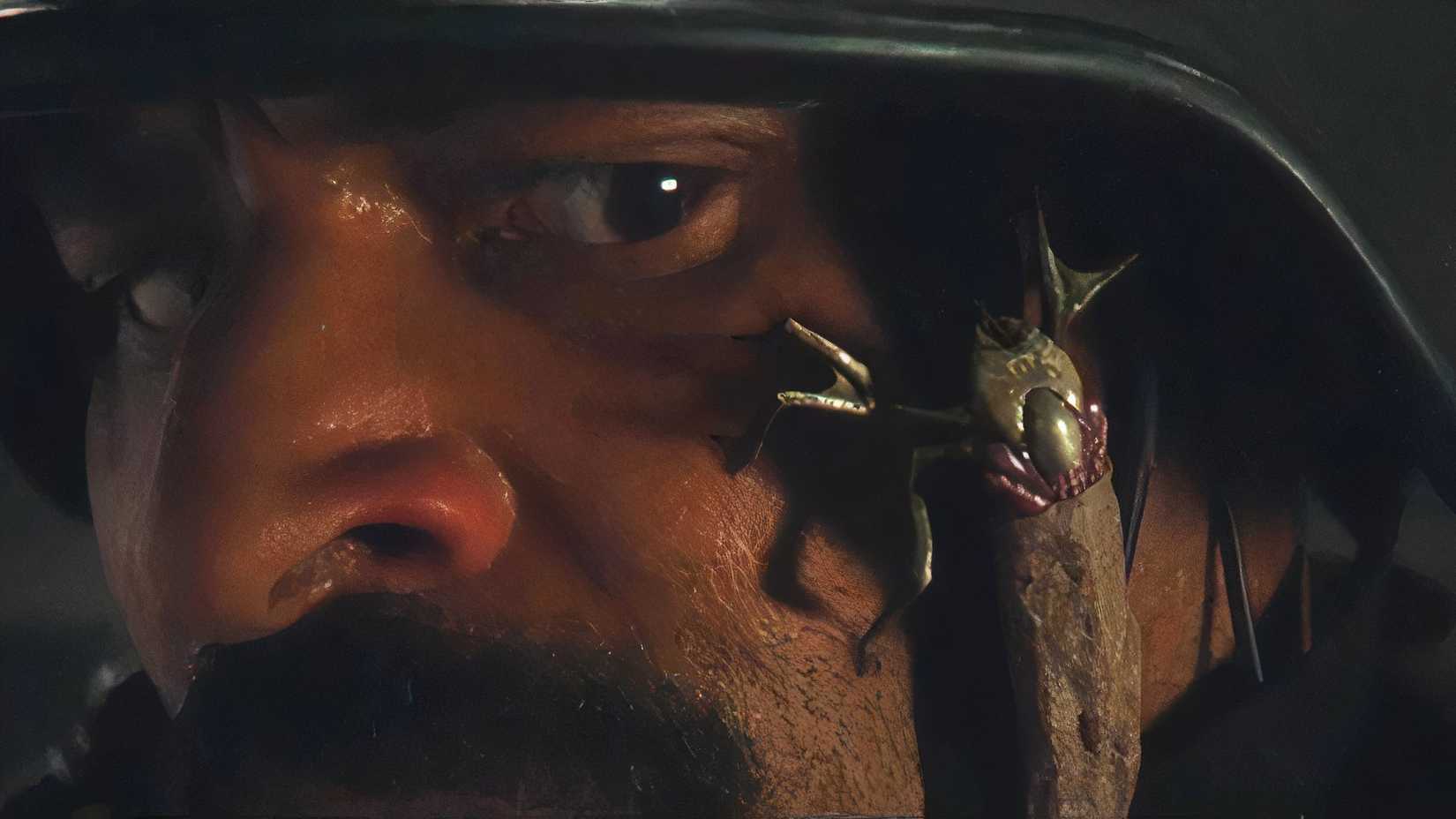 Um dos carrapatos alienígenas: a Terra rasteja no rosto de um soldado.
