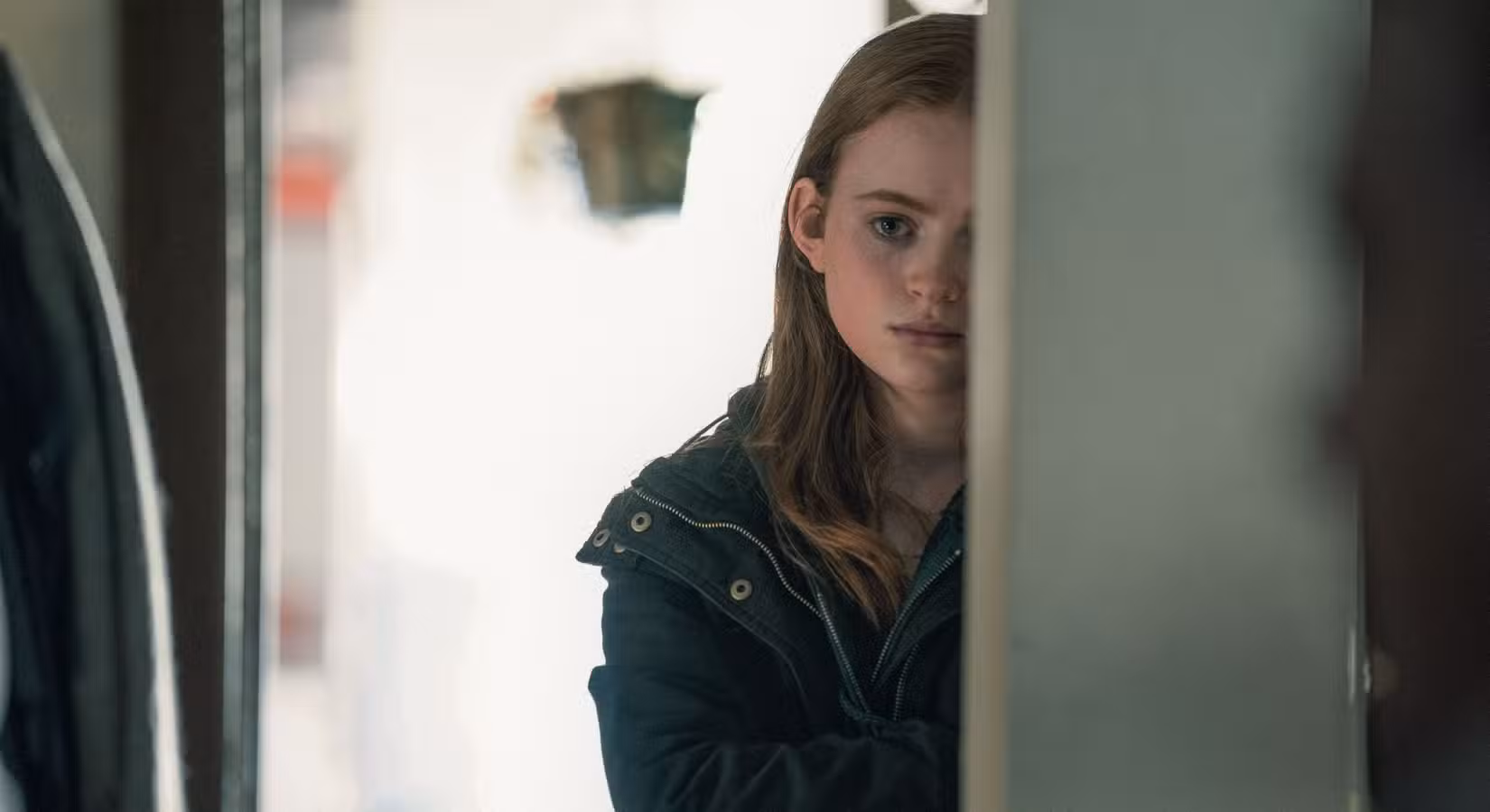 A filha de 17 anos de Charlie, Ellie (Sadie Sink), fica meio eclipsada por uma porta, parecendo triste, em The Whale