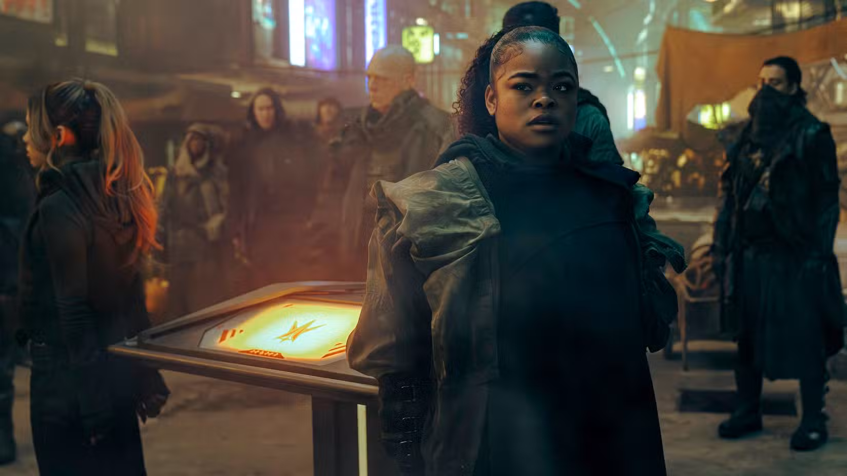 SAM (Kerrice Brooks) parece preocupada enquanto está em um mercado lotado na Academia da Frota Estelar