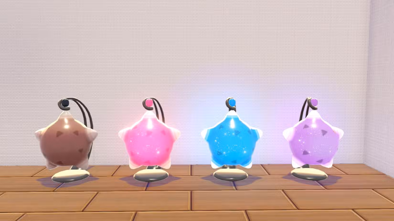 Um display de quatro lâmpadas que parecem Minior em Pokopia, cada uma com uma cor diferente: marrom, rosa, azul e violeta.