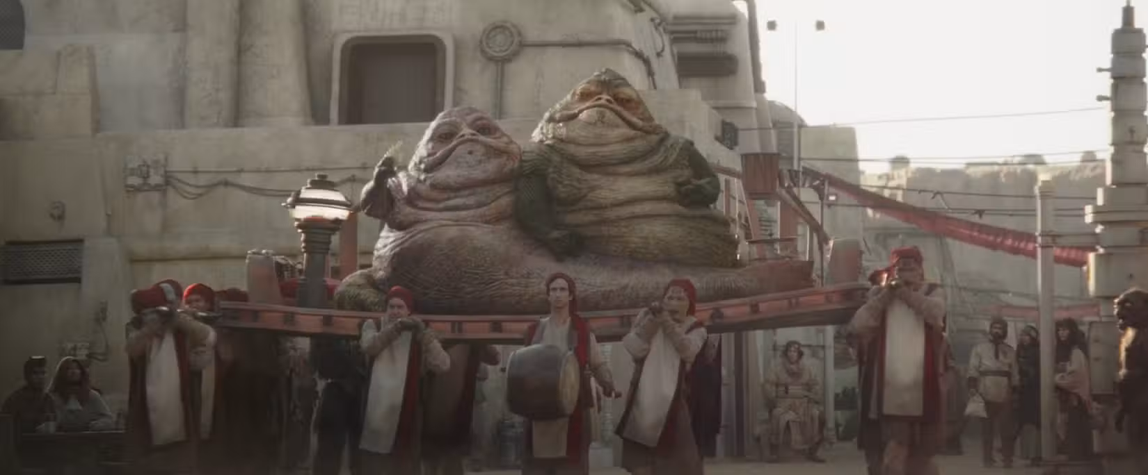Os gêmeos Hutt sendo carregados em uma foto do Livro de Boba Fett