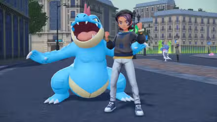 Um treinador posa com Feraligator em Pokémon Legends ZA.