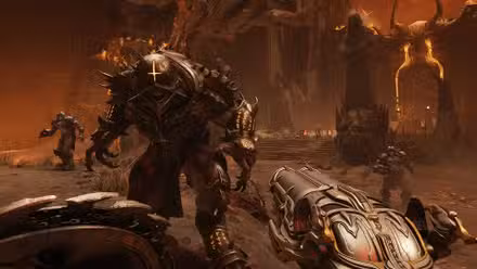 Uma captura de tela em primeira pessoa do Doom Slayer de Doom: The Dark Ages empunhando seu escudo na mão esquerda e uma enorme arma na mão direita enquanto um demônio blindado se aproxima dele